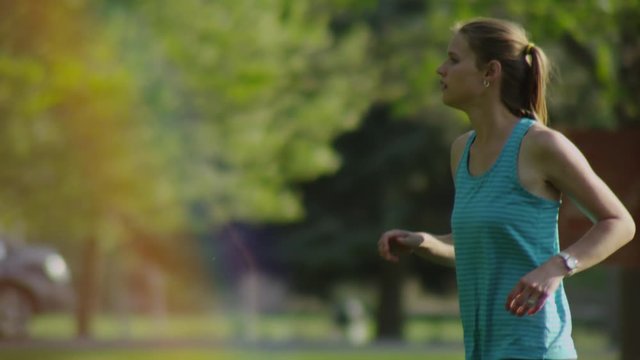 Slow motion woman running in the park