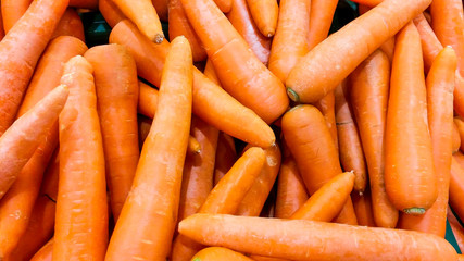 the orange color of carrot on shelf for sell in supermarket