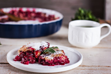 Cherry pie and a cup of tea. Rustic style. Berry pie. Homemade cherry pie with flaky crust, cup of coffee, bowl with cherries