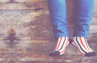 Women's leg in blue denim and striped socks
