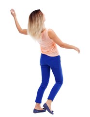 Balancing young woman. or dodge falling woman. Rear view people collection. blonde in a pink t-shirt dodges.
