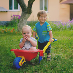 Two little boys toddler playing with colorful children's plastic