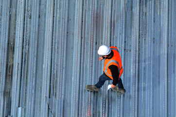 Civil engineers inspecting the work progress of metal roof