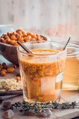 sea buckthorn honey ginger mix in glass with ingredients.