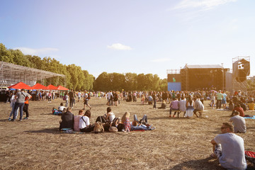 People at open air concert on sunny day - obrazy, fototapety, plakaty