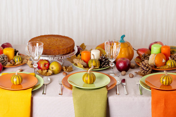 Thanksgiving dinner. Seasonal table setting with autumn leaves,