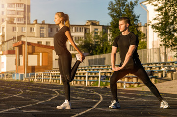 Young adults in sportswear doing warming up