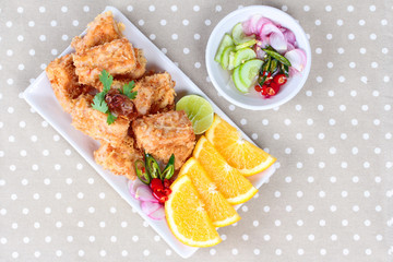 Fried tofu nuggets with minced shrimp and pork on gray background.