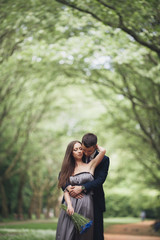 Young beautiful couple, girl with perfect dress posing in park