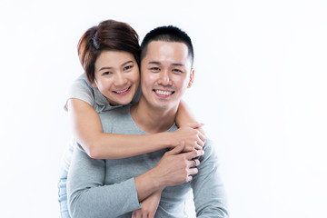 Young and happy Asian couple looking at the camera.