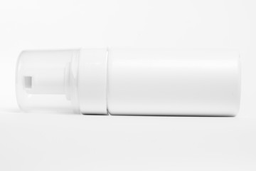 White plastic bottle with spray on white background.
