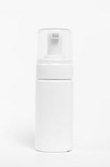 White plastic bottle with spray on white background.
