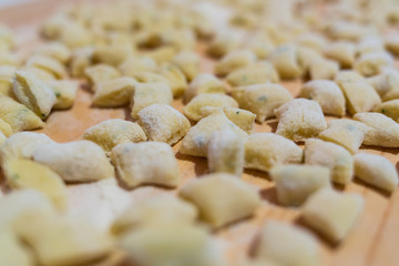 Uncooked homemade gnocchi on cutting board - homemade pasta