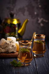 Fototapeta na wymiar Arabic tea with turkish delight and halva