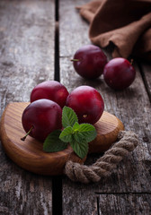 Sweet plums on wooden background