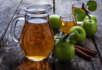 Glasses with apple juice on wooden table