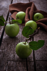 Green apples on wooden background