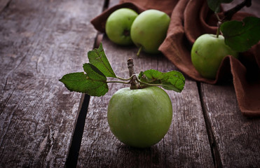Green apples on wooden background
