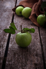 Green apples on wooden background