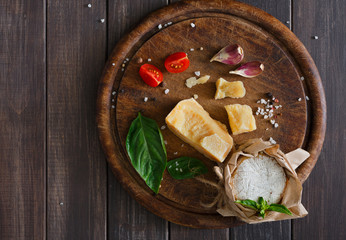 Cheese delikatessen closeup on rustic wood, brie and parmesan