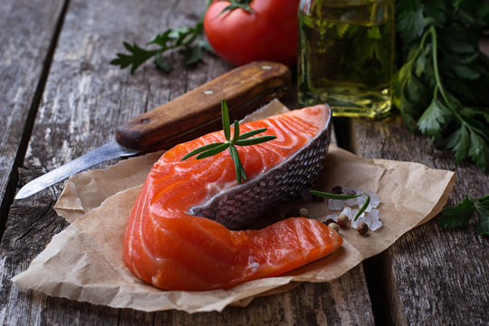 Raw salmon fillet on wooden background