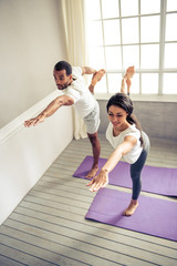 Afro American couple doing yoga