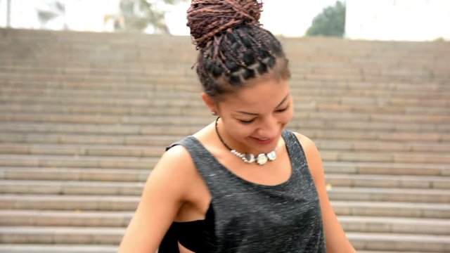 Young woman with cornrows smiling