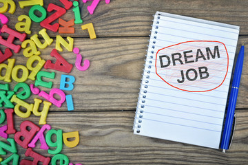 Dream Job text on notepad and magnetic letters