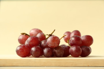 Red grapes on brown background.