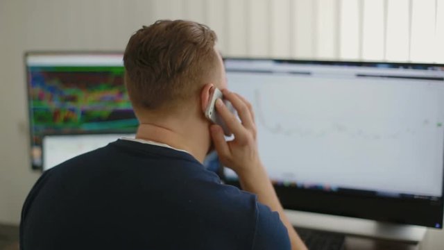 The man speaks by phone with customers