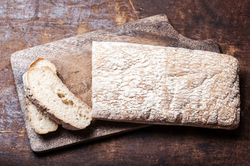 Fresh bread on wooden background. White baked bread on a wooden