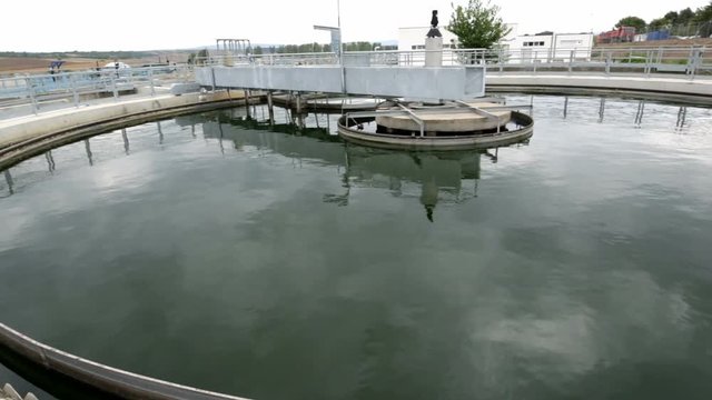 Sludge Recirculation Clarifier Solid Contact Sedimentation Tank. Green dirty water. Wastewater treatment plant. Wastewater treatment is a process used to convert dirty wastewater into an effluent 