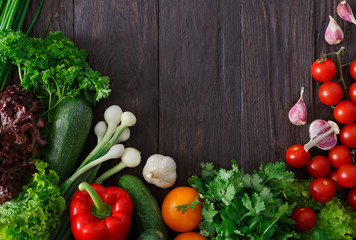 Border of fresh vegetables on wooden background with copy space