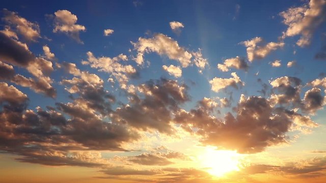 Sunrise. Colorful clouds and sun. Sunlight and shadows. Time lapse