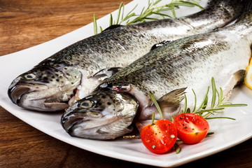 Fresh raw trout on wooden background