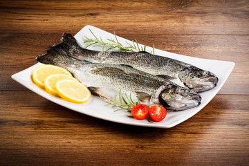 Fresh raw trout on wooden background