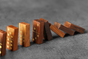 Wooden dominoes on grey table