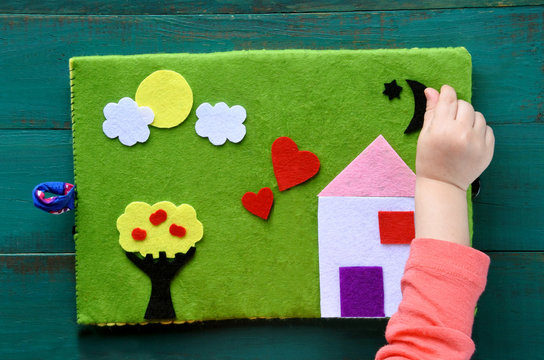 Child hand plays with Felt Creations - Quiet Books