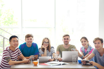 Young people with gadgets hanging out together