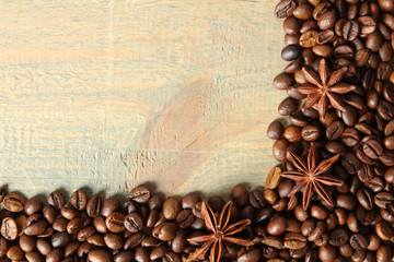 Coffee beans on wooden brown background. Copy space