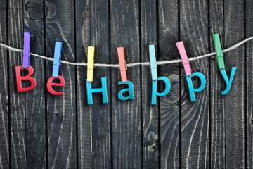 Be Happy word hanging on clips