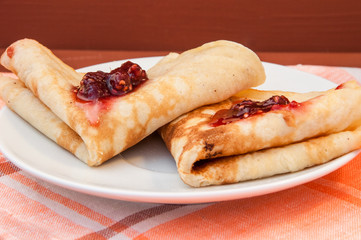 Two pancakes with strawberry jam