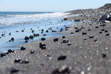 black sand and waves in the  beach with soft focus
