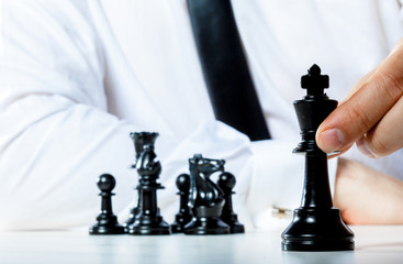 Hand of businessman playing chess