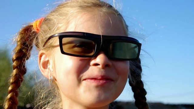 Girl wears 3D glasses