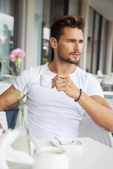 Portrait of young model drinking coffee