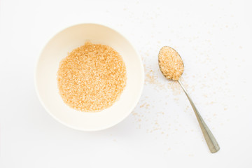 granulated brown sugar in spoons