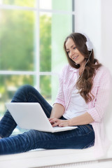 young woman  in headphones with laptop