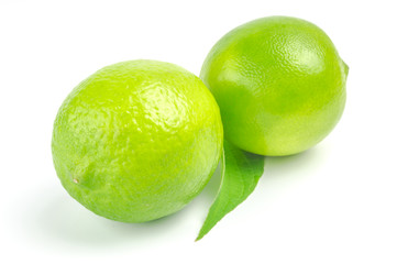 Two lime with leaf isolated on white background