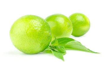 Three fresh limes in row Isolated on white with leaves